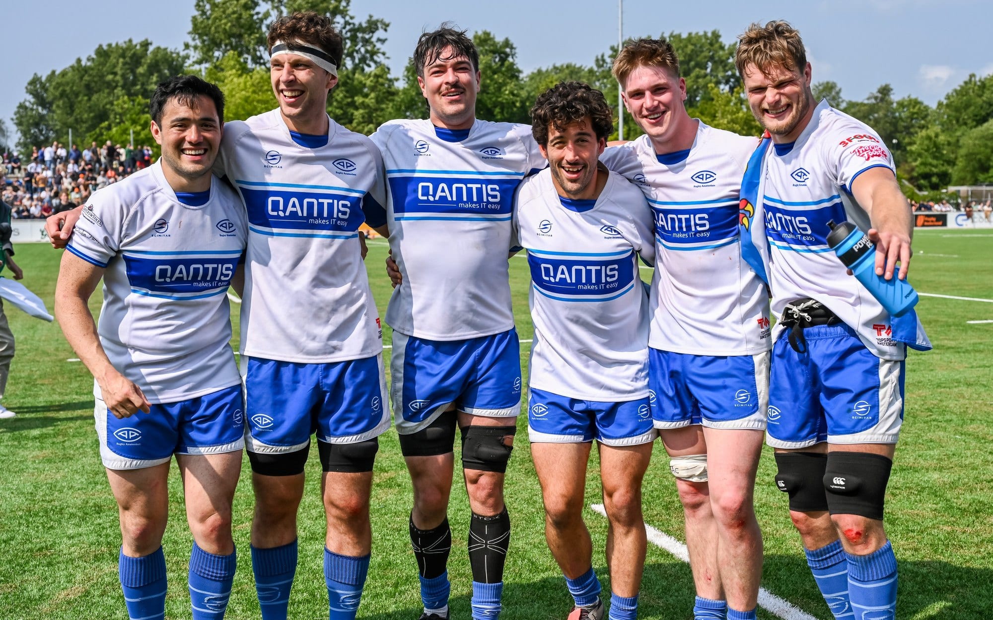 AAC players in club kit with the QANTIS jersey sponsor across the chest