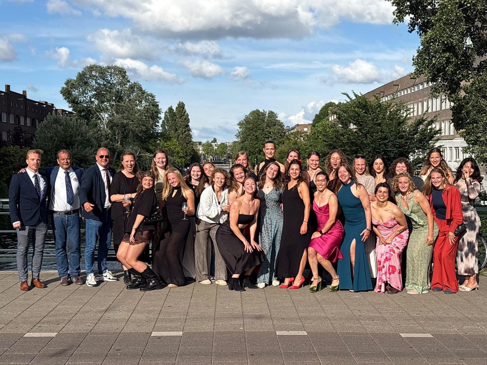 The AAC women's squad dressed up for the end-of-season celebration, lined up along an Amsterdam canal