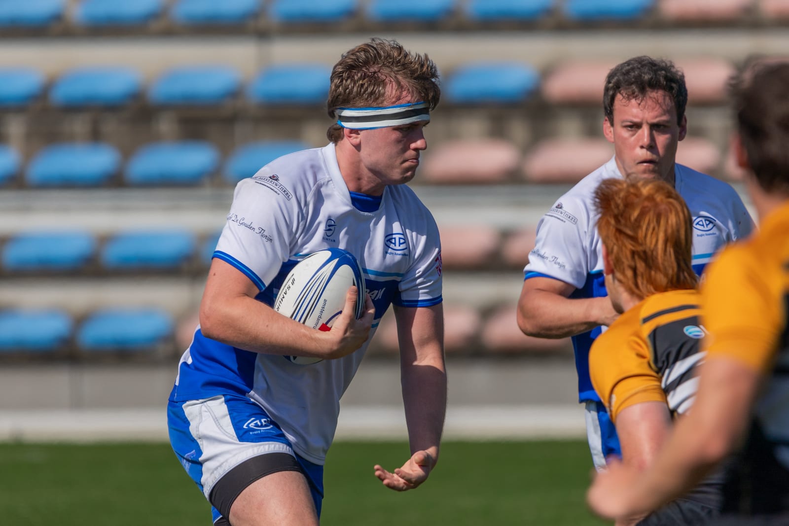 AAC men's player carries the ball into contact against BRC