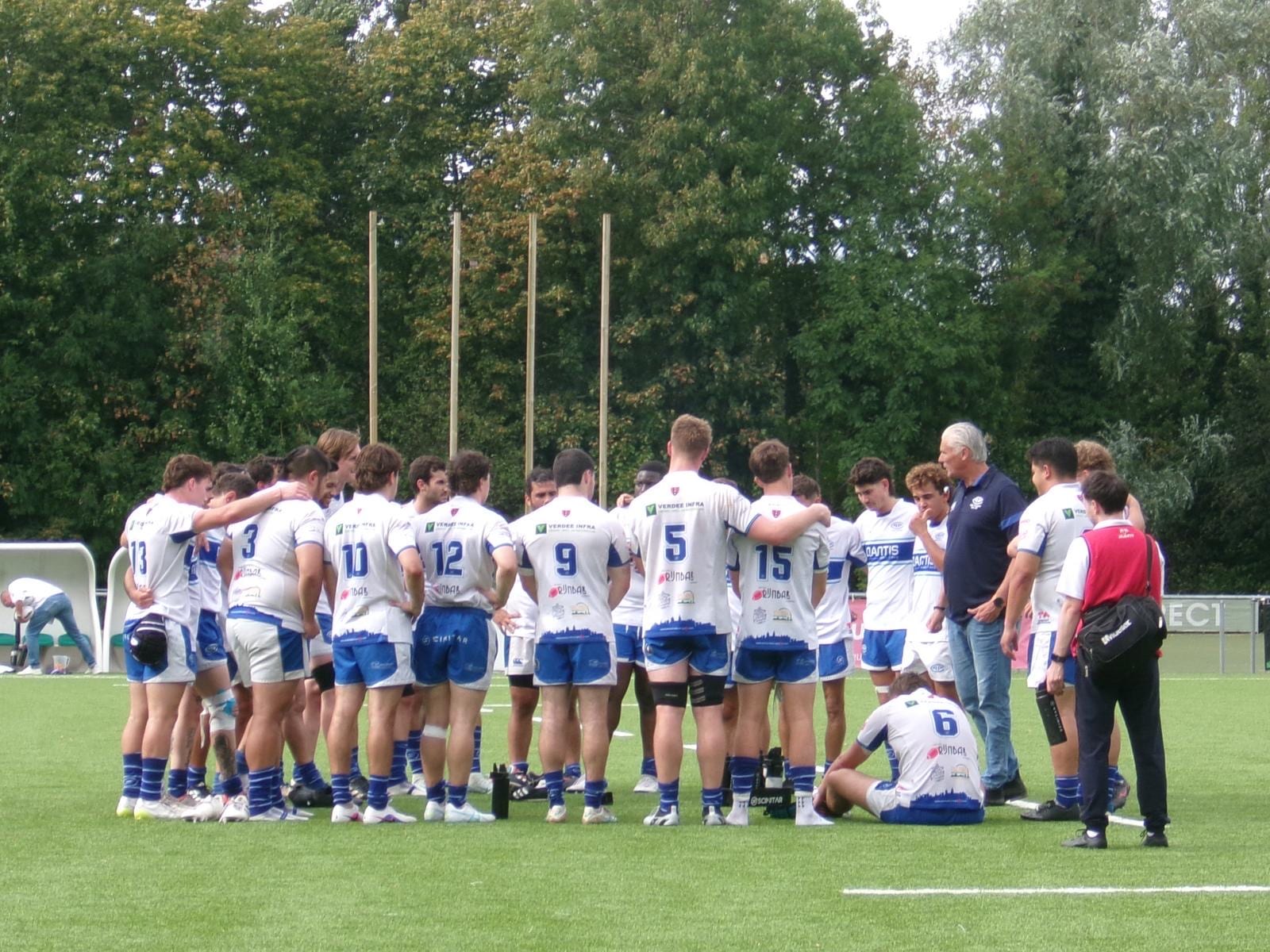 AAC players in a huddle on the pitch during the pre-season friendly against Royal Kituro