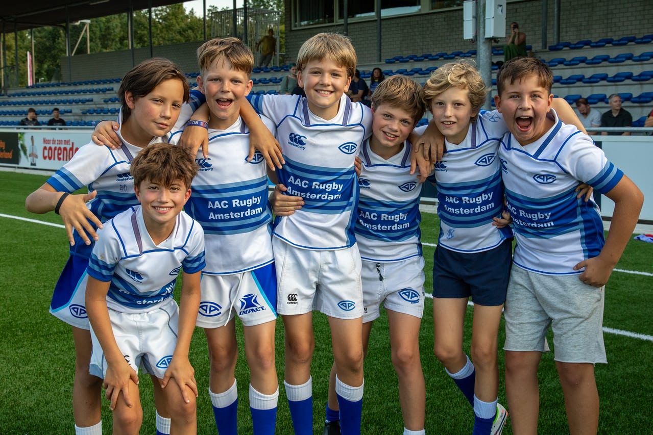 AAC youth players in club kit lined up by the pitch