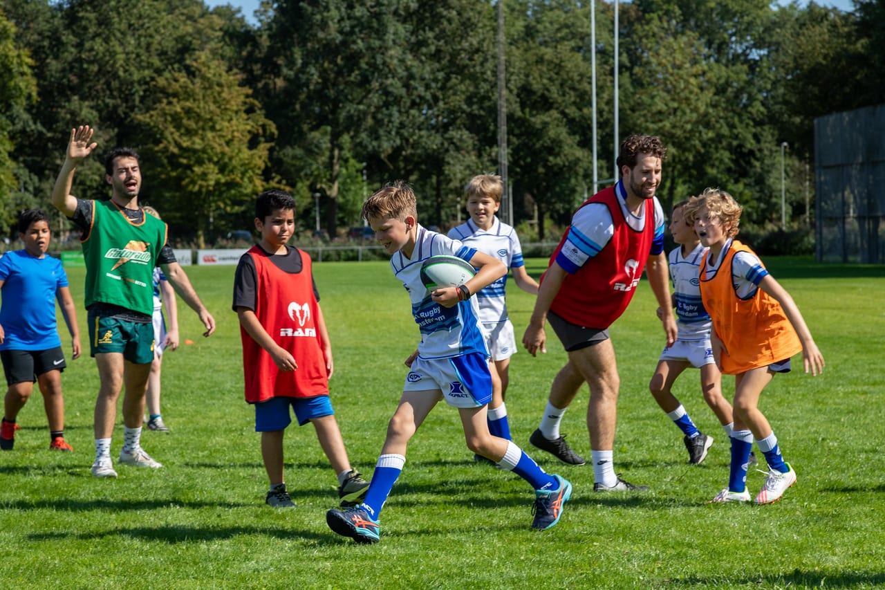 Young AAC player carries the ball in youth training