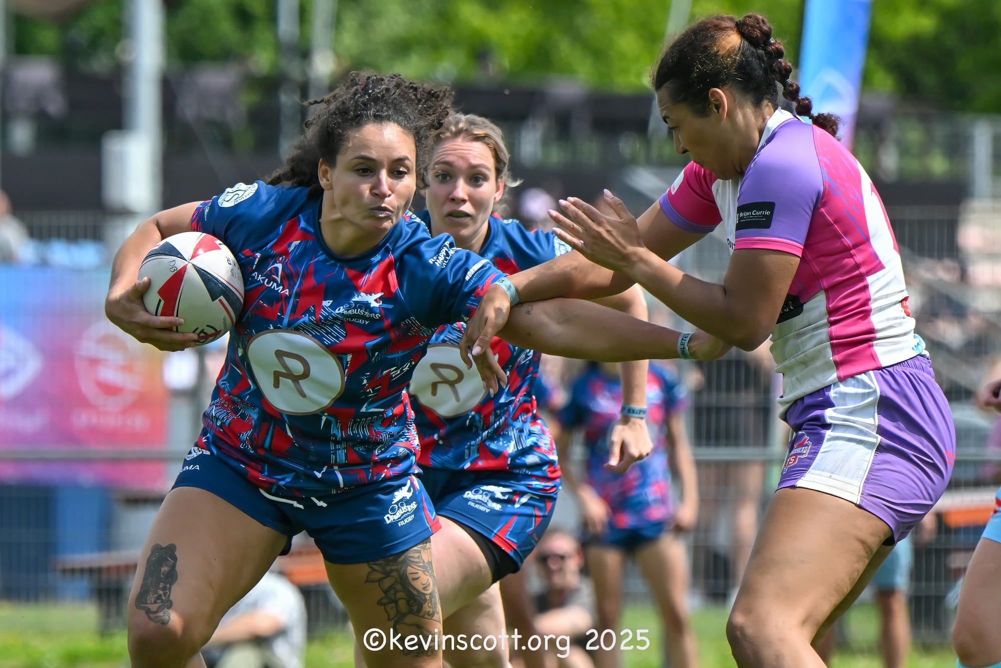 A women’s sevens ball-carrier breaks past a defender at the 2025 Amsterdam Sevens
