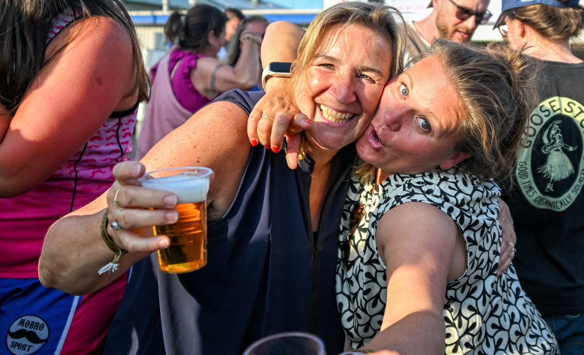 Two players hug and toast with a beer at the Amsterdam Sevens after-party