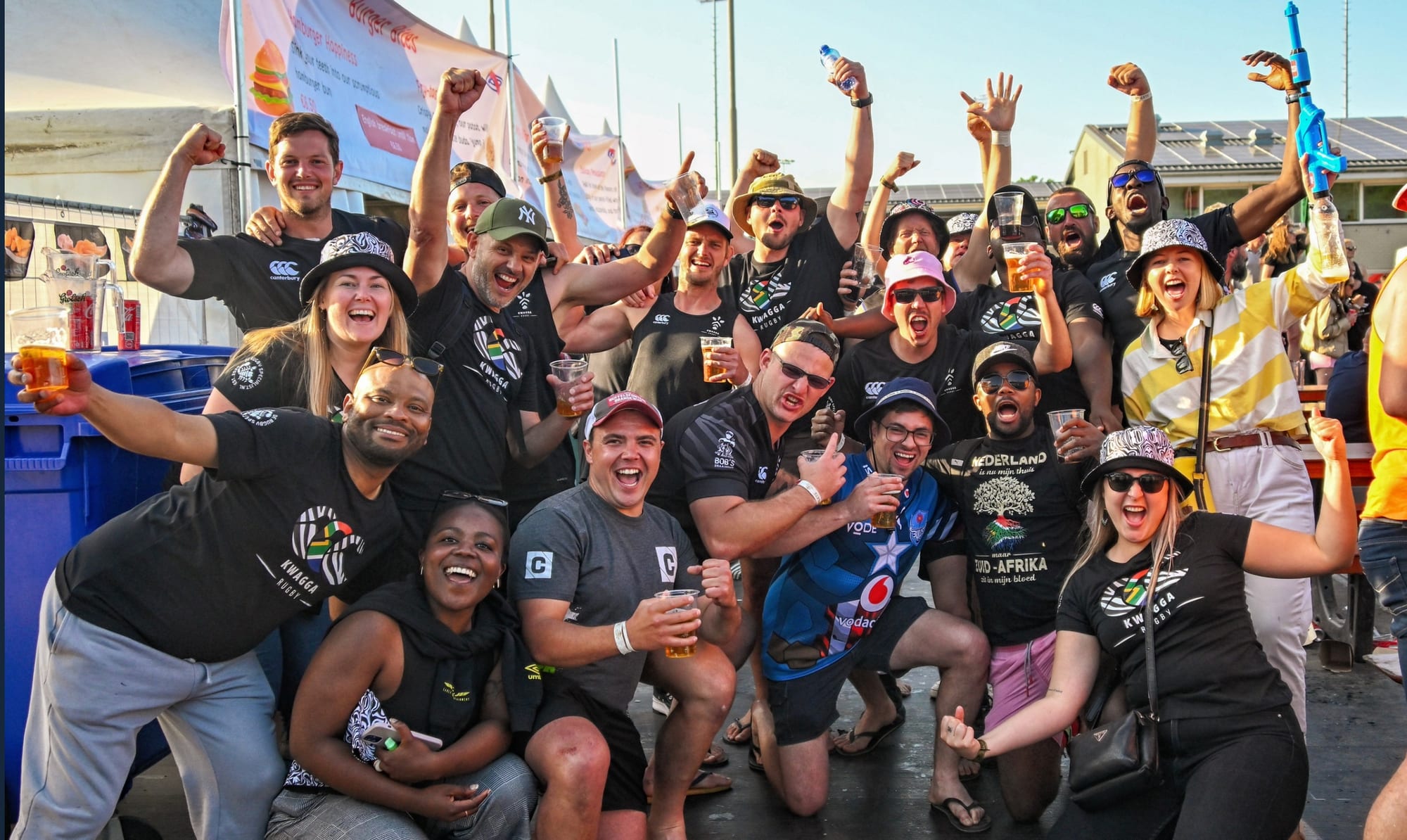 A touring side in matching kit celebrates together at the Amsterdam Sevens after-party