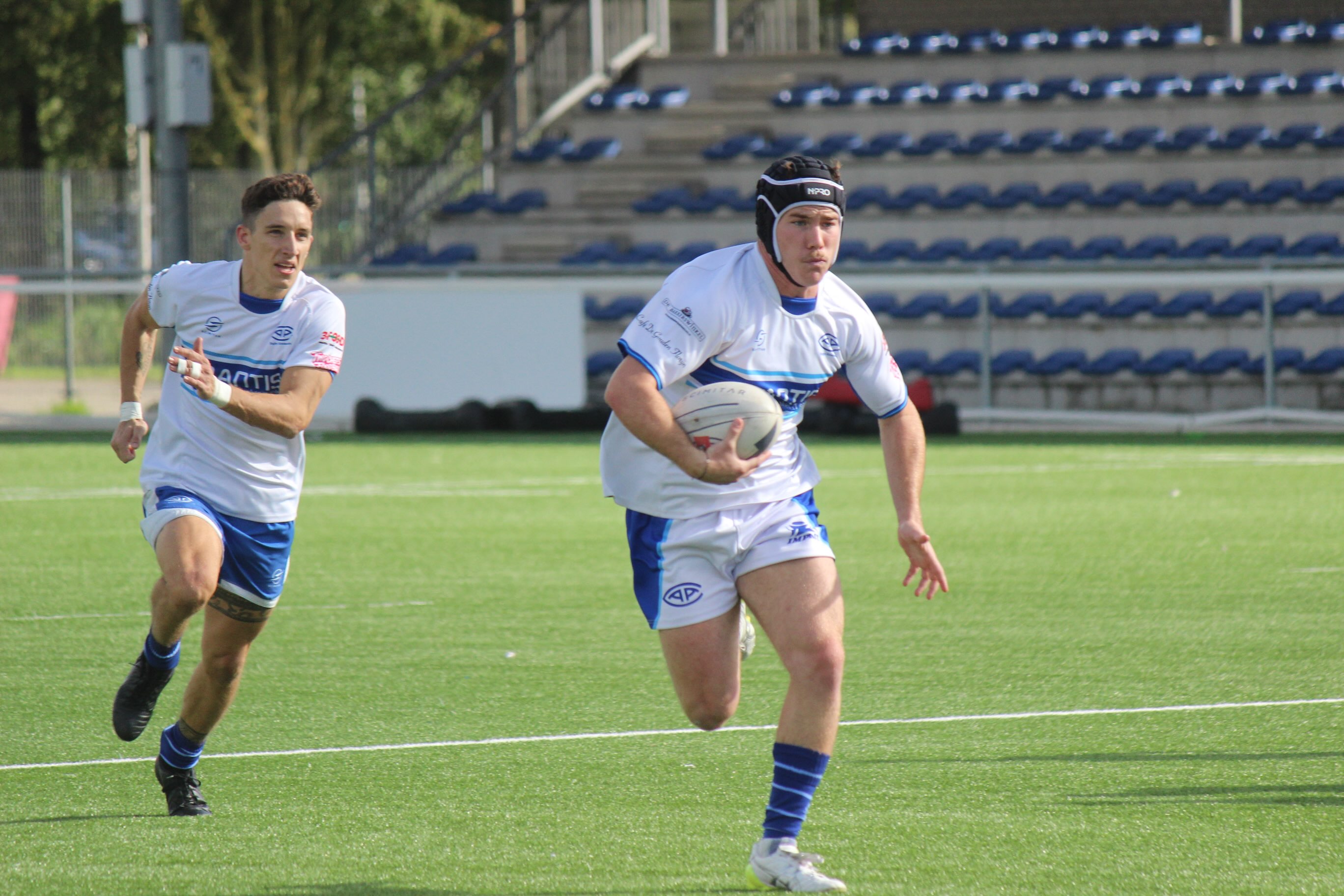 An AAC player in dark blue kit contests a line-out against RC Bulldogs