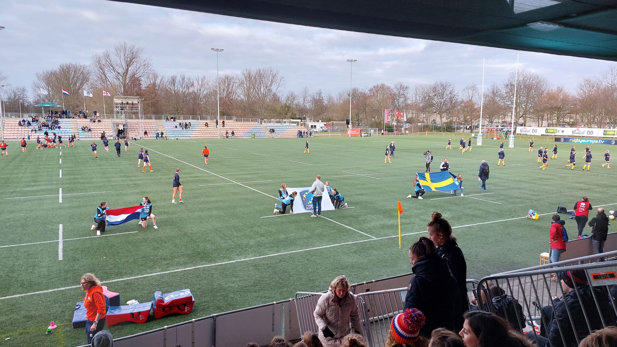 Women's international match at the NRCA Stadium, with the covered stand behind the main pitch